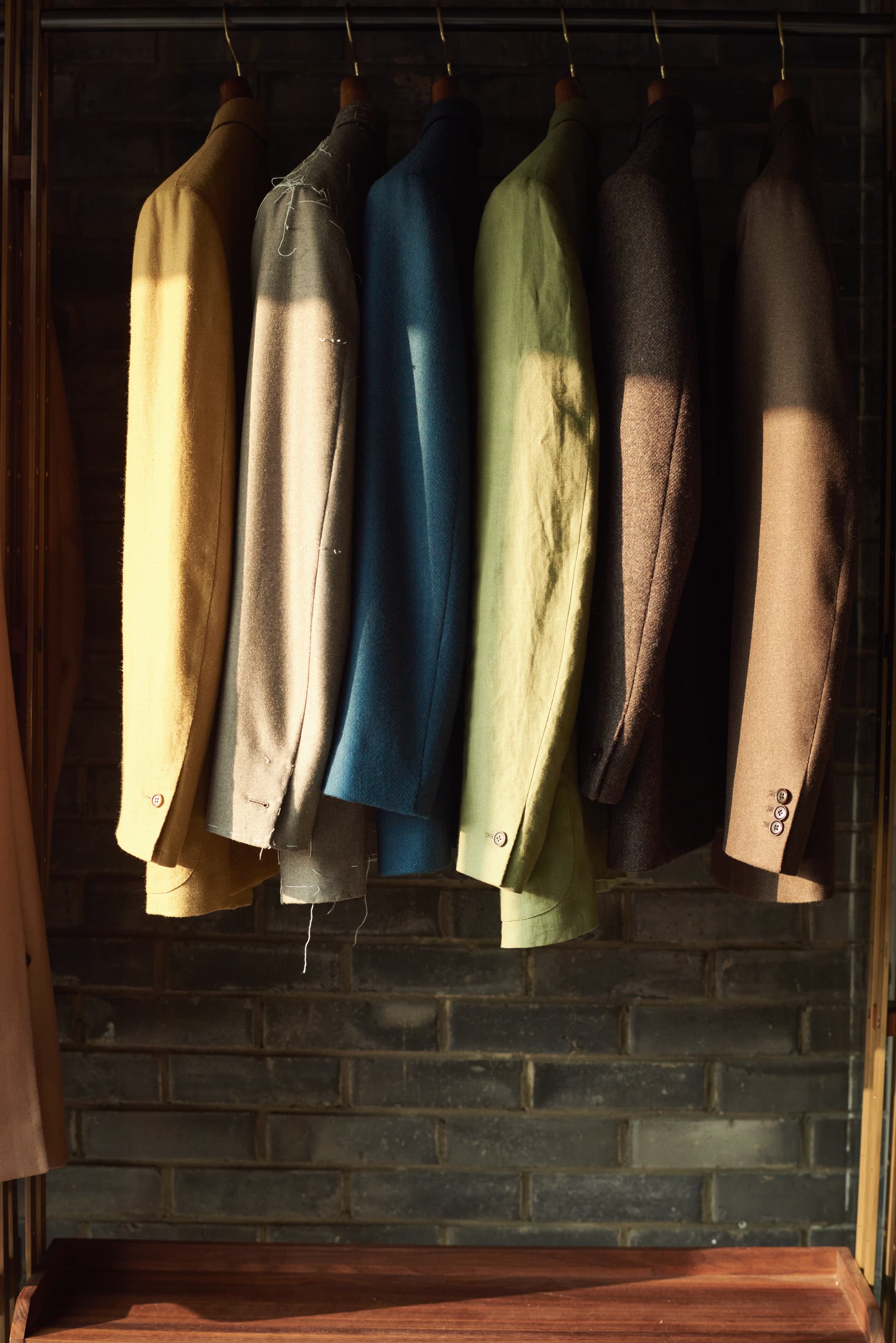 Jackets of various colors and moon jars in the workshop